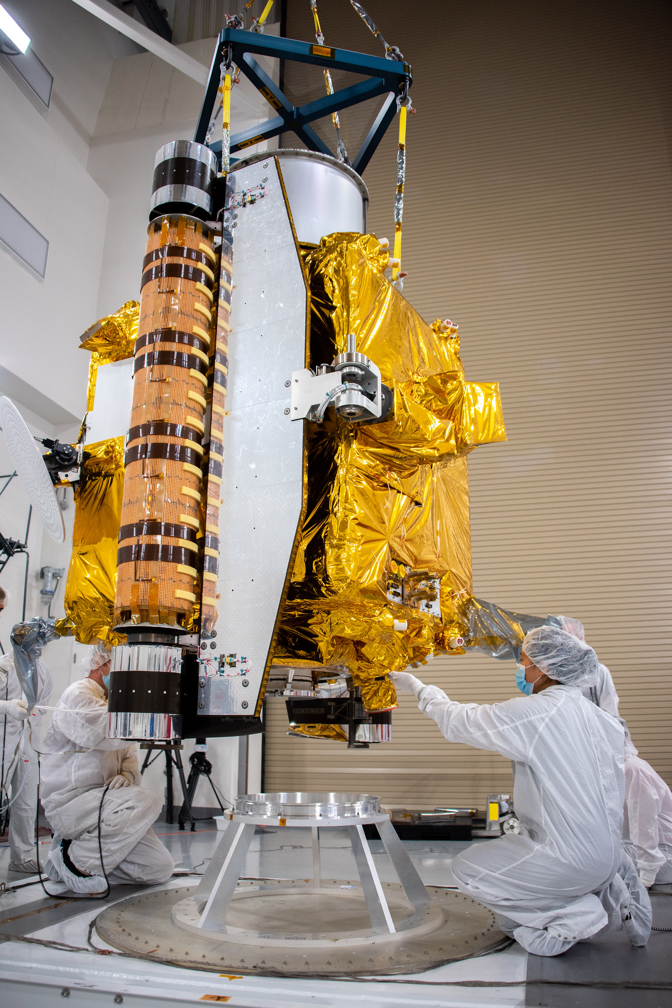 Persons in cleanroom garments inspecting DART satellite at Astrotech Vandenberg
Photo: NASA